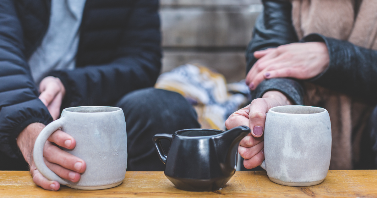 A man and a woman sharing coffee engaged in conmversation