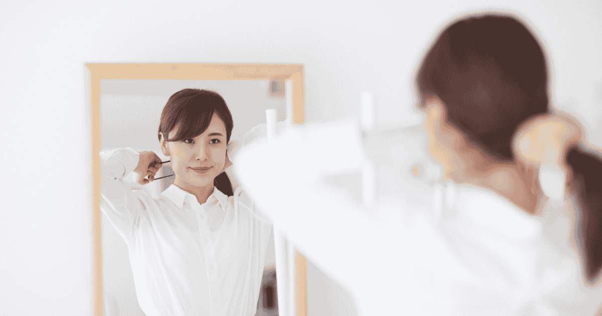 A woman in front of a mirror building her confidence